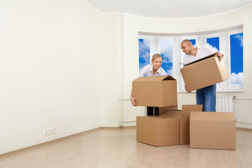 Removal van and moving boxes near residential homes in Penge