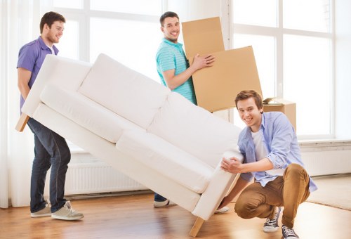 Moving team carrying household furniture in Penge