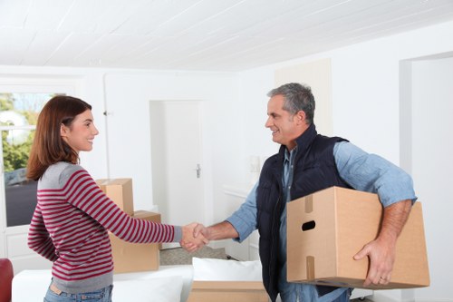 Professional removal team handling packed boxes for a Penge house move